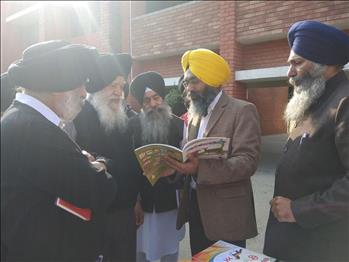 Dr. Varinderpal Singh discussing the school books concept with the dignitaries