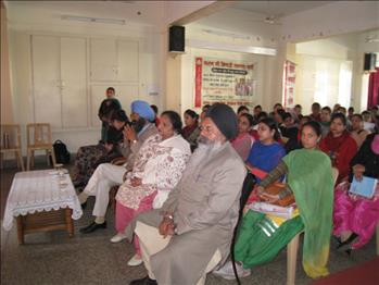 Dignitaries attentively listening to the honorable speaker
