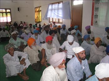 Farmers listening sensibly to the orator.
