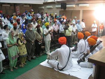 Attendees taking part in Shabad Kirtan recitation at the start of conference.