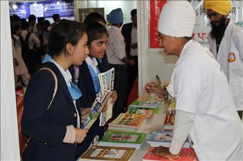 Volunteers exhibiting books published by Atam pargas publications