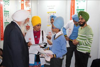 Student discussing her essay with Atam Pargas evaluator during the Punjabi writing event