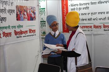 Student being explained the rules for participation in Punjabi writing event