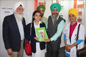 Student receiving Atam pargas publication book as a prize for best essay