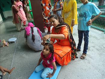 Another delegate doing the sewa of getting the children ready for school.
